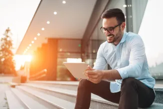 Businessman in glasses holding tablet